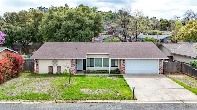 ranch-style home featuring a garage, a front yard, brick siding, and fence