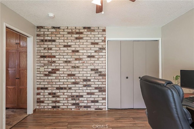 office with a textured ceiling, wood finished floors, and ceiling fan