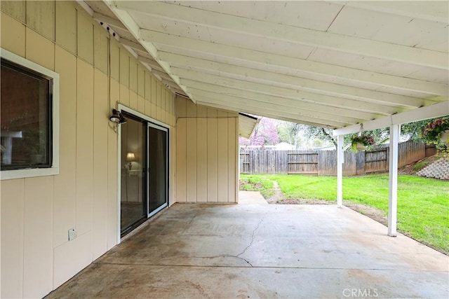 view of patio featuring a carport and fence