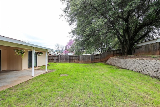 view of yard with a fenced backyard and a patio