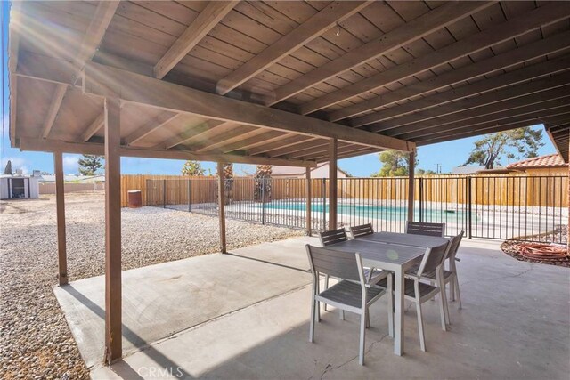 13206 Winona Rd, Apple Valley, CA 92308 - view of patio / terrace featuring a fenced in pool, outdoor dining area, and a fenced backyard
