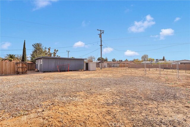 13206 Winona Rd, Apple Valley, CA 92308 - view of yard with an outbuilding and fence