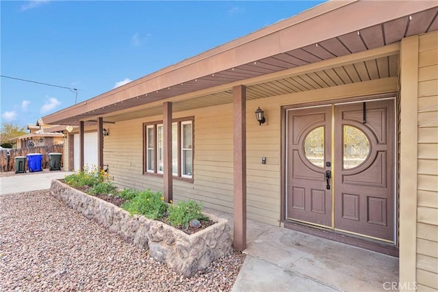 13206 Winona Rd, Apple Valley, CA 92308 - view of exterior entry with covered porch, a garage, and driveway