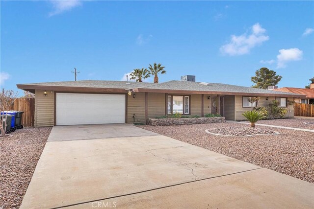 13206 Winona Rd, Apple Valley, CA 92308 - ranch-style house with concrete driveway, a garage, and fence