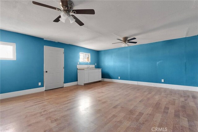 13206 Winona Rd, Apple Valley, CA 92308 - spare room featuring ceiling fan, light wood finished floors, baseboards, and a textured ceiling
