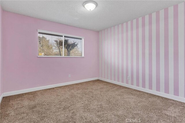 13206 Winona Rd, Apple Valley, CA 92308 - unfurnished room featuring wallpapered walls, carpet flooring, a textured ceiling, and baseboards