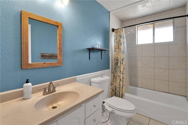 13206 Winona Rd, Apple Valley, CA 92308 - bathroom featuring vanity, a wainscoted wall, toilet, shower / bath combo with shower curtain, and a textured wall