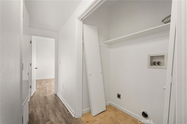 laundry area featuring laundry area, wood finished floors, hookup for an electric dryer, washer hookup, and baseboards
