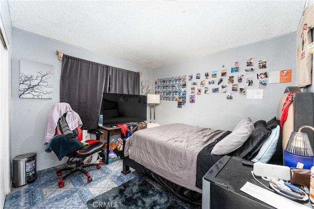 bedroom with tile patterned floors and a textured ceiling