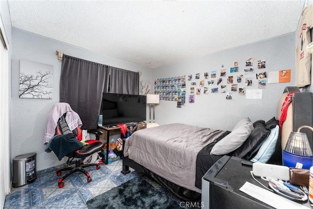 860 3rd St, Rialto, CA 92376 - bedroom with tile patterned floors and a textured ceiling