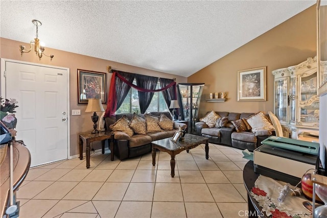 living area with lofted ceiling, a textured ceiling, light tile patterned floors, and a chandelier