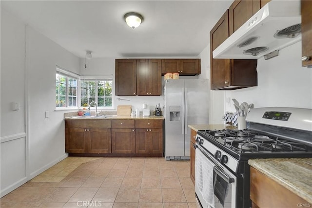 13031305 E Kingsley Ave, Pomona, CA 91767 - kitchen with light tile patterned floors, a sink, under cabinet range hood, stainless steel appliances, and light stone counters
