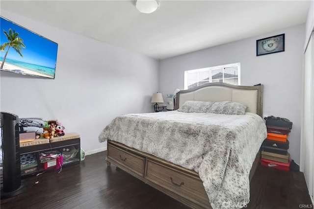 13031305 E Kingsley Ave, Pomona, CA 91767 - bedroom featuring dark wood-style flooring and baseboards