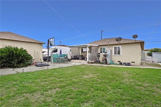 13031305 E Kingsley Ave, Pomona, CA 91767 - rear view of house featuring a yard, a patio, stucco siding, and fence