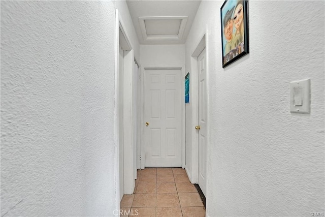 13031305 E Kingsley Ave, Pomona, CA 91767 - hall with a textured wall, light tile patterned floors, and attic access