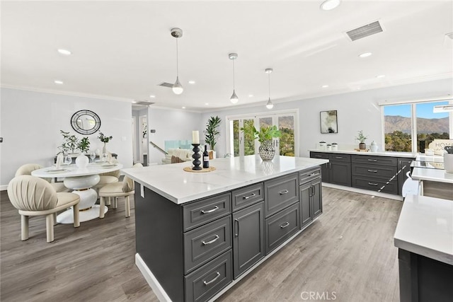 334 Anita Dr, Pasadena, CA 91105 - kitchen with light countertops, ornamental molding, a kitchen island, recessed lighting, and light wood finished floors