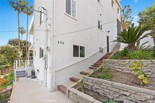 334 Anita Dr, Pasadena, CA 91105 - view of side of home featuring stairway and stucco siding
