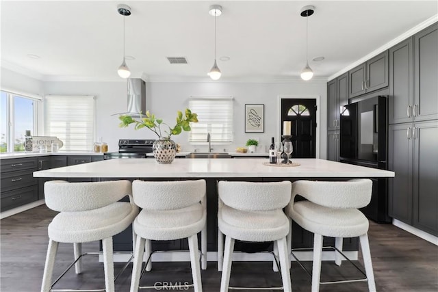 334 Anita Dr, Pasadena, CA 91105 - kitchen with wall chimney range hood, electric range, freestanding refrigerator, light countertops, and crown molding