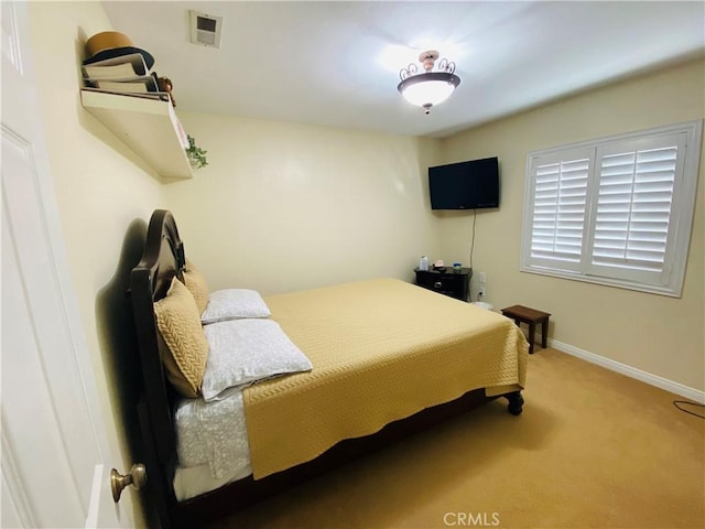 carpeted bedroom featuring visible vents and baseboards