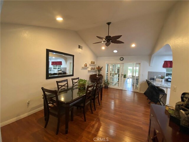 dining space featuring vaulted ceiling, visible vents, wood finished floors, baseboards, and ceiling fan