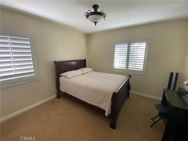 carpeted bedroom with baseboards