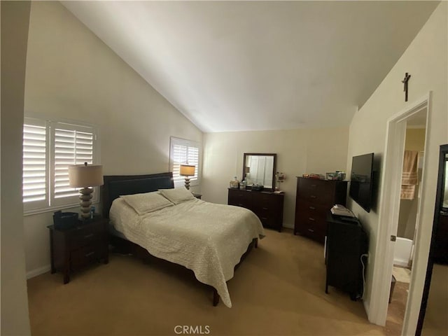 bedroom featuring baseboards, vaulted ceiling, and light colored carpet
