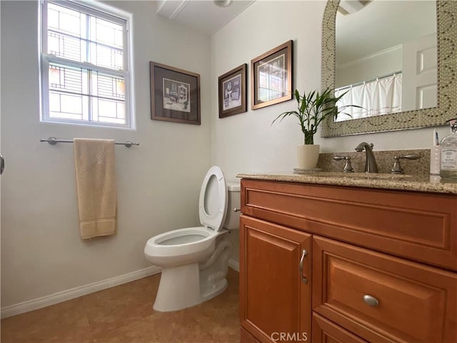full bathroom with baseboards, vanity, and toilet