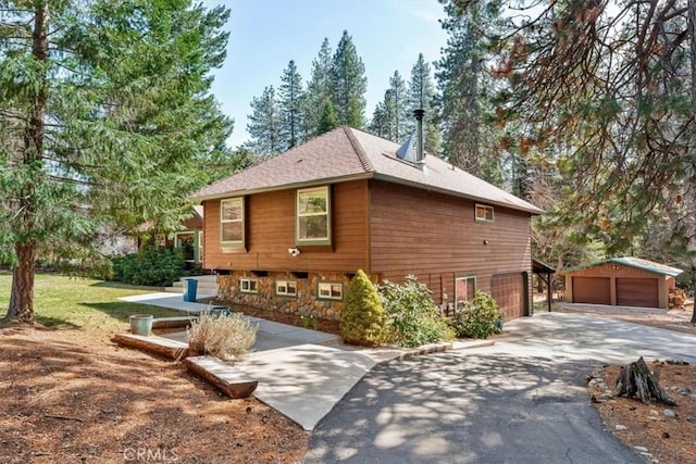 view of home's exterior featuring stone siding and an outdoor structure