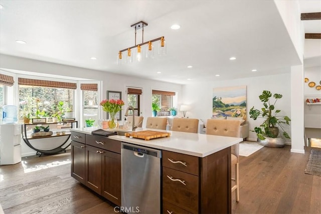 kitchen with dark wood-type flooring, light countertops, recessed lighting, and dishwasher