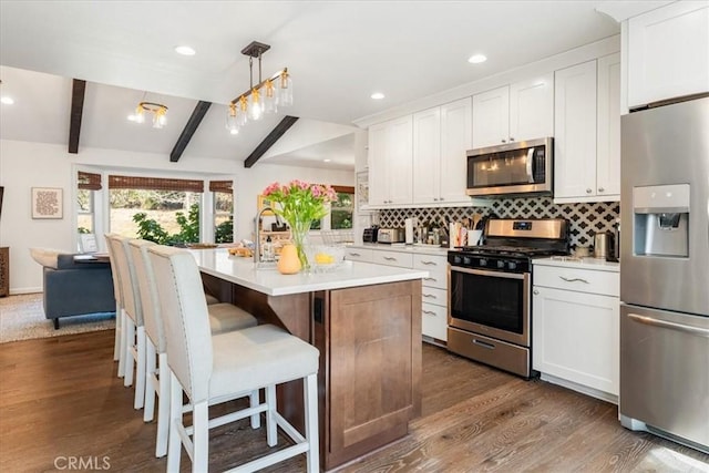 2605 Fryers Way, Mount Shasta, CA 96067 - kitchen with stainless steel appliances, light countertops, dark wood finished floors, decorative backsplash, and beam ceiling