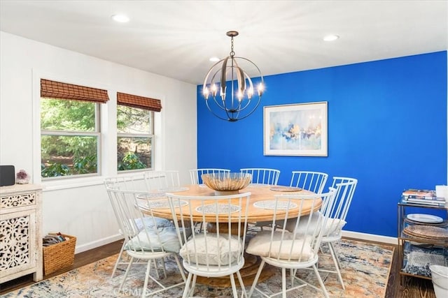 dining area with baseboards, recessed lighting, and an inviting chandelier