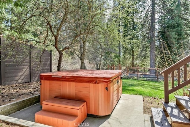 view of patio with a fenced backyard and a hot tub