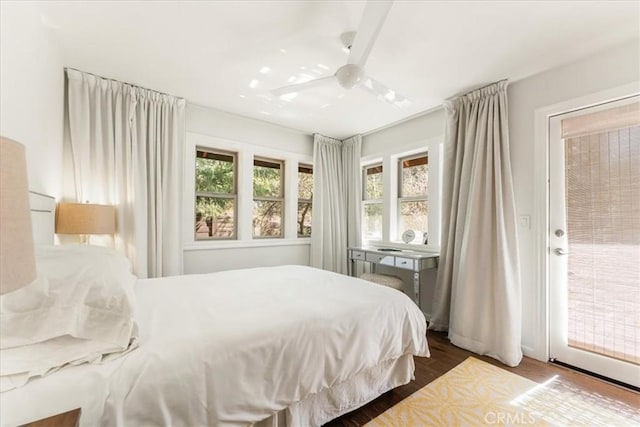 bedroom with access to outside, a ceiling fan, and wood finished floors