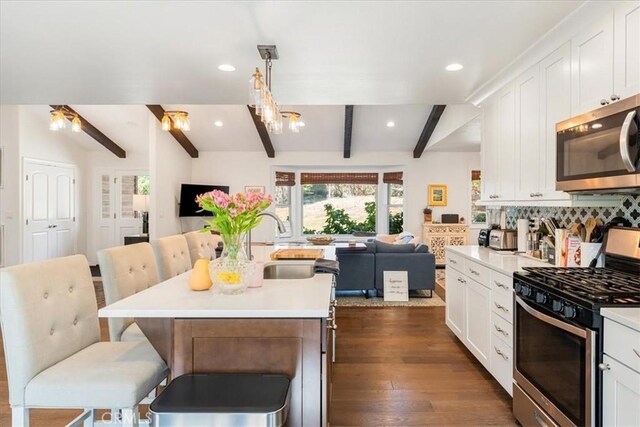 2605 Fryers Way, Mount Shasta, CA 96067 - kitchen featuring open floor plan, appliances with stainless steel finishes, beamed ceiling, white cabinets, and a breakfast bar