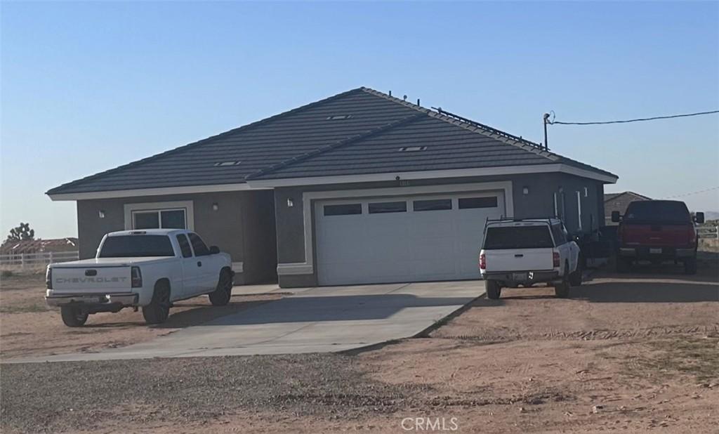 ranch-style house with concrete driveway and an attached garage