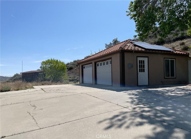 garage with roof mounted solar panels