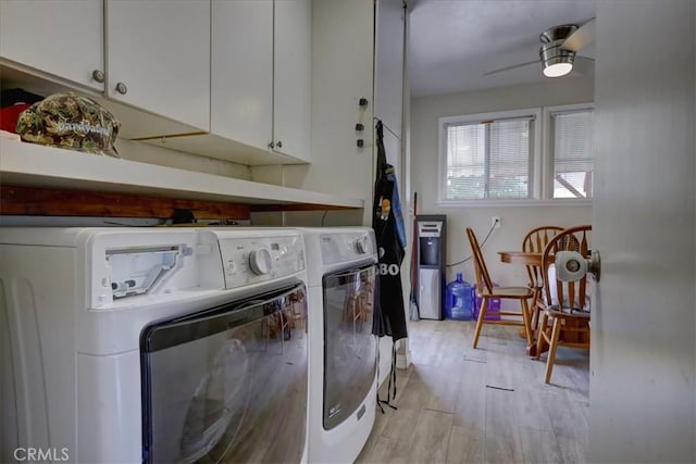 clothes washing area featuring light wood-style floors, separate washer and dryer, ceiling fan, and cabinet space