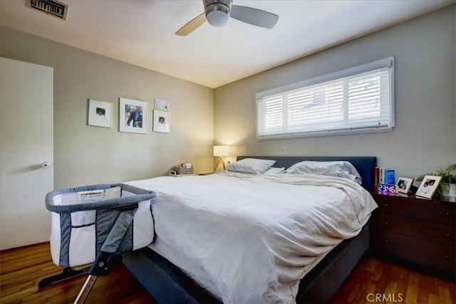 bedroom featuring wood finished floors, ceiling fan, and visible vents
