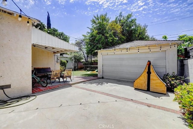 detached garage featuring fence