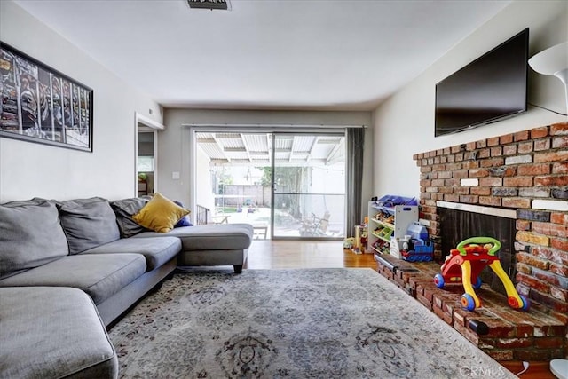 living area featuring wood finished floors and a fireplace