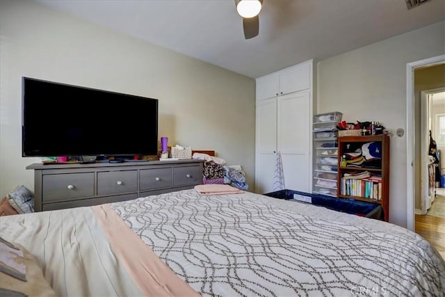 bedroom with wood finished floors, a closet, and a ceiling fan