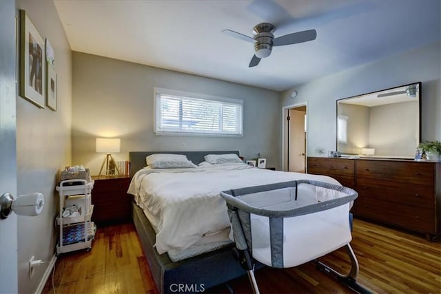 bedroom with baseboards, a ceiling fan, and wood finished floors