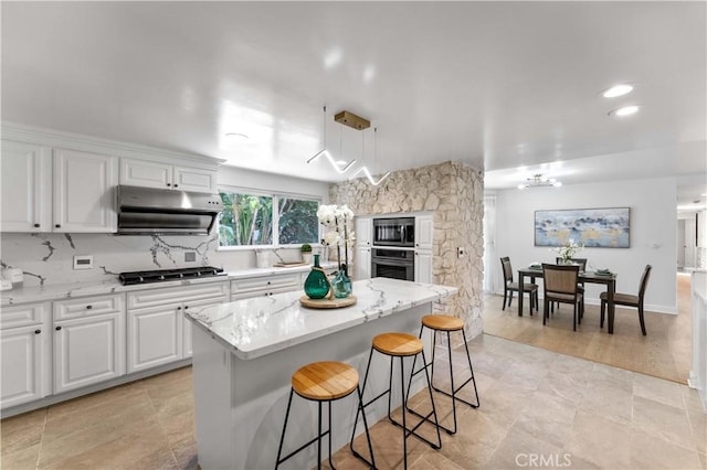 950 S Spring Meadow Dr, West Covina, CA 91791 - kitchen with under cabinet range hood, appliances with stainless steel finishes, white cabinetry, a center island, and recessed lighting
