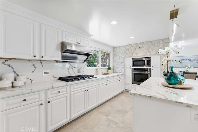 950 S Spring Meadow Dr, West Covina, CA 91791 - kitchen with appliances with stainless steel finishes, under cabinet range hood, white cabinets, tasteful backsplash, and light stone countertops