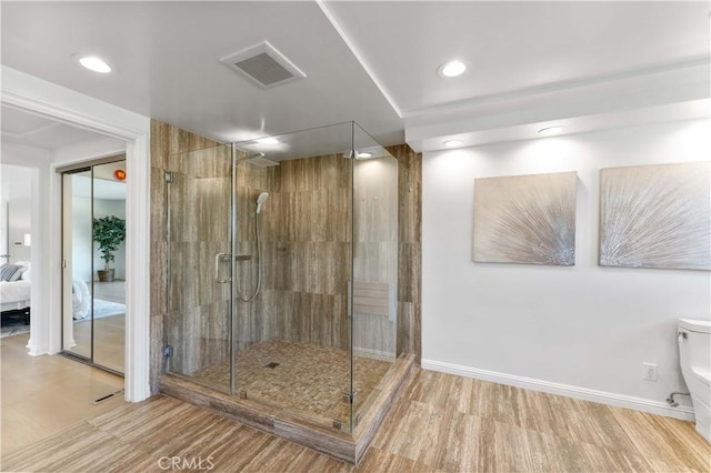 950 S Spring Meadow Dr, West Covina, CA 91791 - ensuite bathroom featuring toilet, recessed lighting, a shower stall, wood finished floors, and baseboards