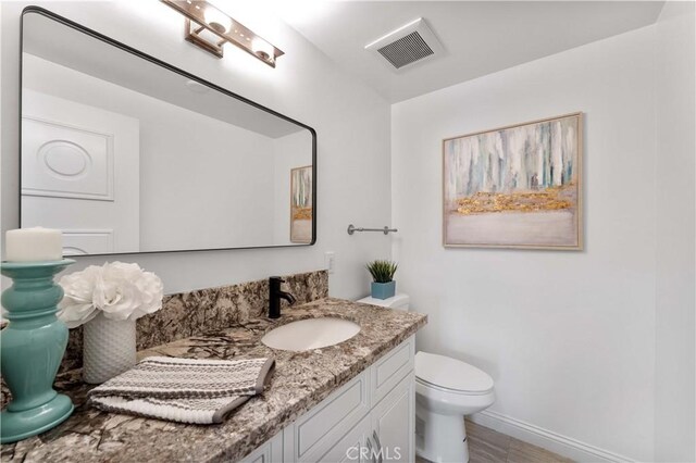 950 S Spring Meadow Dr, West Covina, CA 91791 - half bath with vanity, toilet, baseboards, and wood finished floors