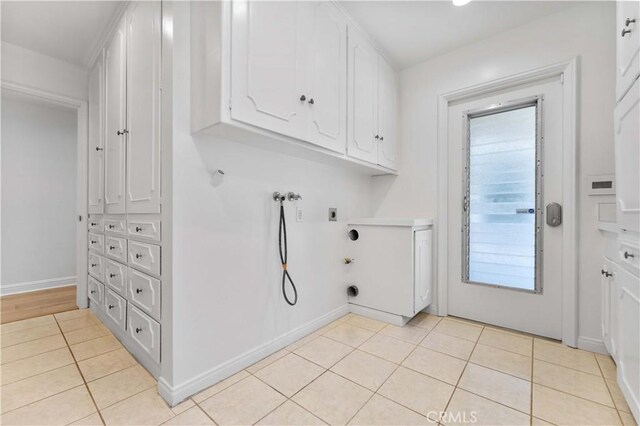 950 S Spring Meadow Dr, West Covina, CA 91791 - laundry area with hookup for a gas dryer, hookup for an electric dryer, cabinet space, washer hookup, and light tile patterned floors