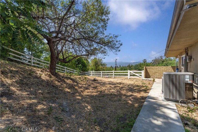 950 S Spring Meadow Dr, West Covina, CA 91791 - fenced backyard with cooling unit and a view of countryside