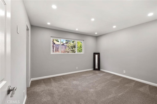 carpeted spare room with baseboards and recessed lighting