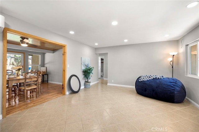 sitting room with baseboards, recessed lighting, and light tile patterned flooring